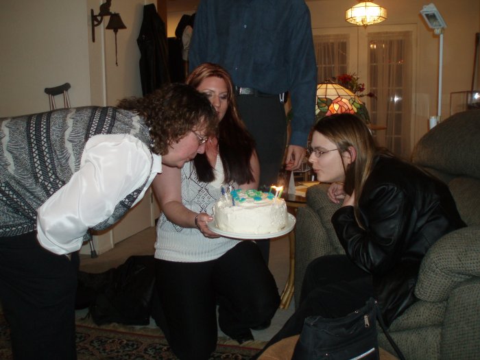 The two birthday girls blow out their candles