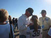 Dick Rutan signing his autograph for his granddaughter